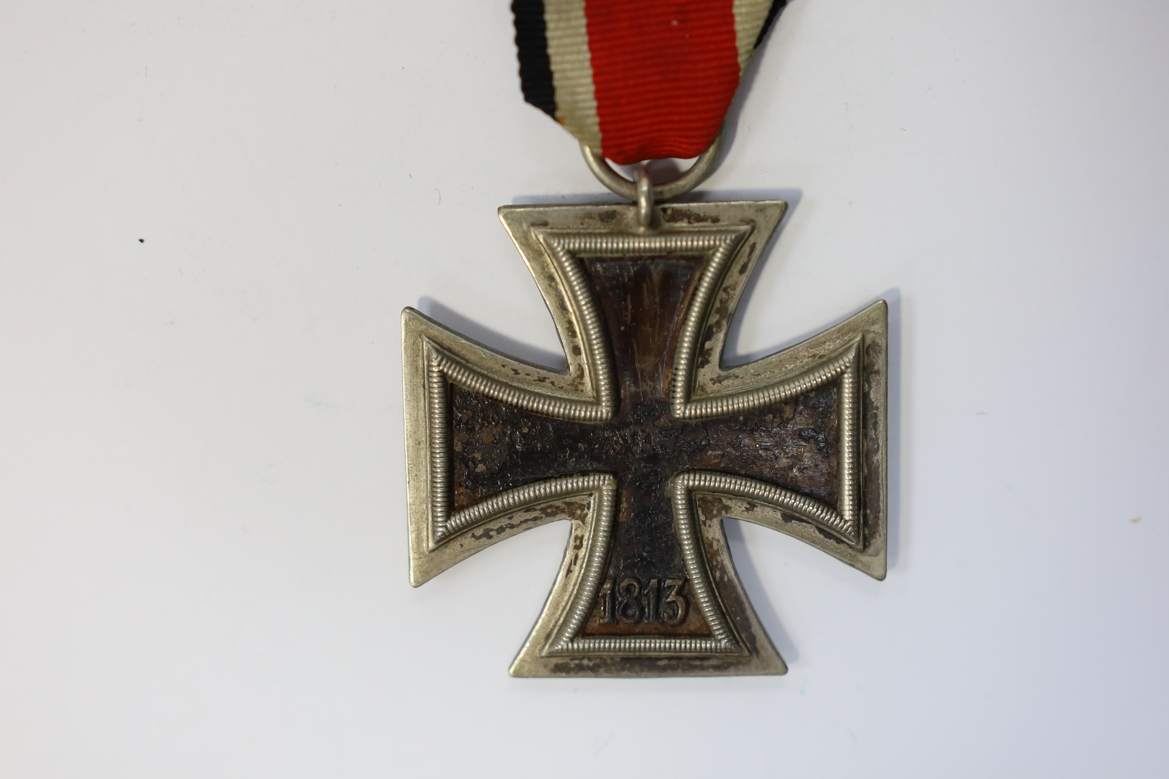 A WWII Iron Cross. Condition - poor, black paint now mainly missing from surface.